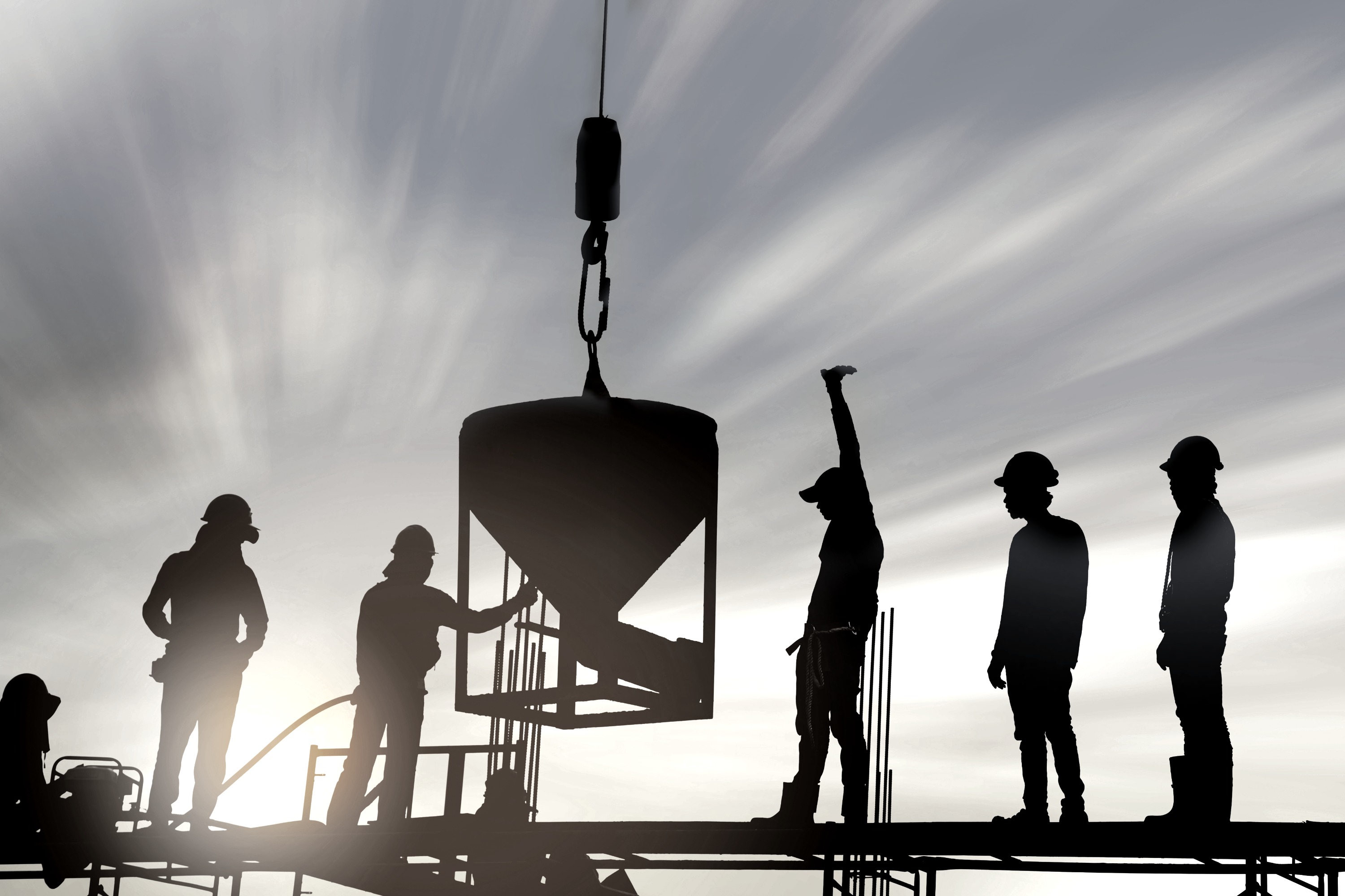 Illustrative crane lifting construction material at a commercial project site